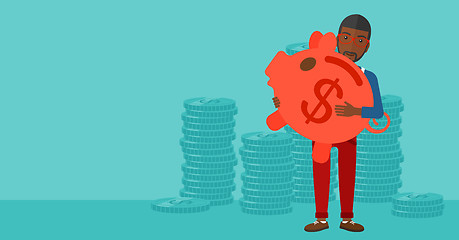 Image showing Man carrying piggy bank.