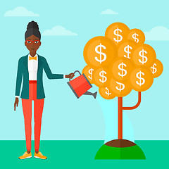 Image showing Woman watering money tree.