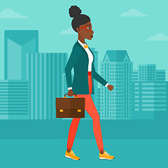 Image showing Business woman walking with briefcase. 