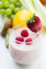 Image showing close up of glass with milk shake and fruits