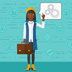 Image showing Business woman pointing at cogwheels.