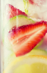 Image showing close up of fruit water in glass bottle