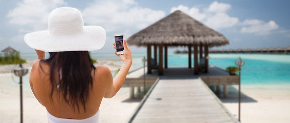 Image showing smiling young woman taking selfie with smartphone