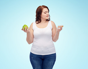 Image showing young plus size woman choosing apple or cookie