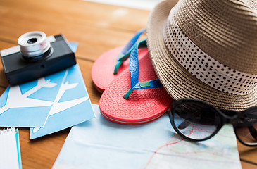 Image showing close up of travel map, flip-flops, hat and camera