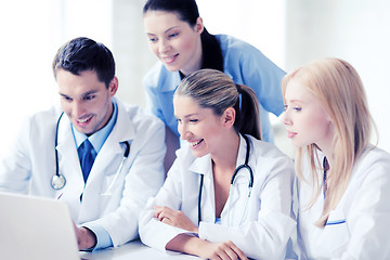 Image showing group of doctors looking at tablet pc