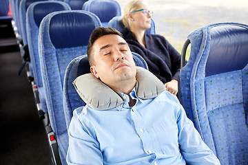 Image showing man sleeping in travel bus with cervical pillow