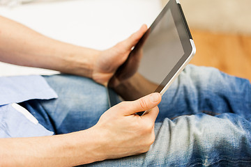 Image showing close up of man working with tablet pc at home