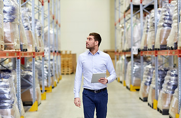 Image showing businessman with tablet pc at warehouse