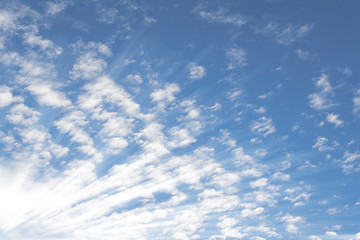 Image showing Summer sky with small Altocumulus clouds and bright sunrays sunb