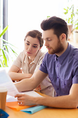 Image showing creative team with reading paper in office