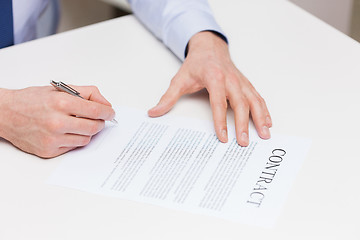 Image showing close up of male hands signing contract document