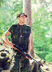 Image showing young soldier or hunter with gun in forest