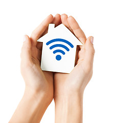 Image showing hands holding house with radio wave signal icon