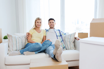 Image showing happy couple with big cardboard boxes at new home