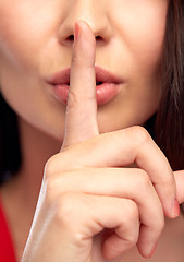 Image showing close up of woman face holding finger on her lips