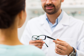 Image showing close up of optician with glasses at optics store