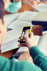 Image showing student hands with smartphone making cheat sheet