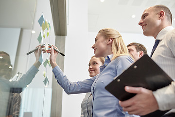 Image showing smiling business people with marker and stickers