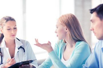 Image showing doctor with patients in cabinet