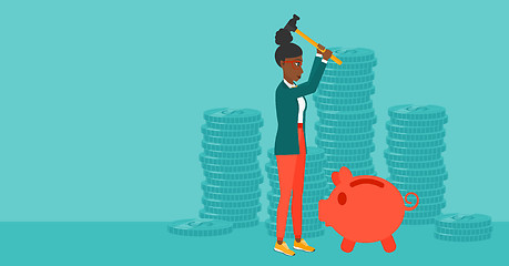 Image showing Woman breaking piggy bank.