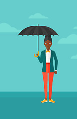 Image showing Business woman standing with umbrella.