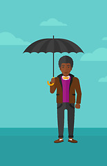 Image showing Businessman standing with umbrella.