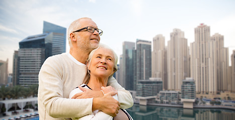 Image showing senior couple hugging over dubai city waterfront