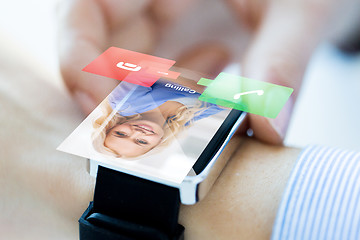 Image showing close up of hand with incoming call on smart watch