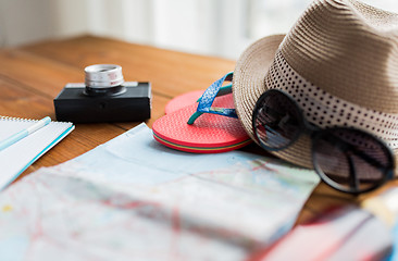 Image showing close up of travel map, flip-flops, hat and camera