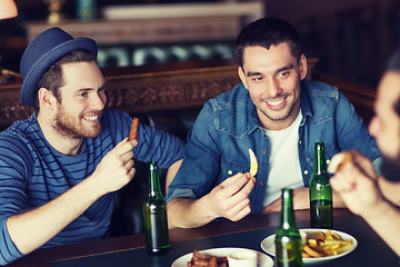 Image showing happy male friends drinking beer at bar or pub