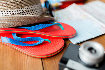 Image showing close up of travel map, flip-flops, hat and camera