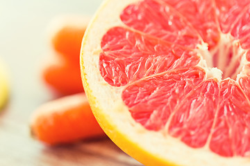 Image showing close up of fresh juicy grapefruit slice on table