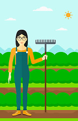 Image showing Farmer with rake.