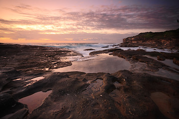 Image showing Yena Bay rockshelf low tide at dawn.  