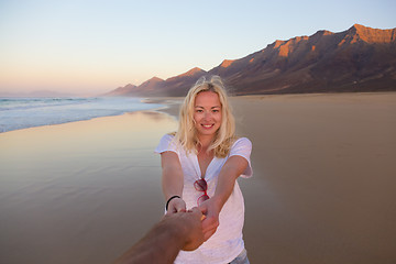 Image showing Romantic couple holding hands on beach.