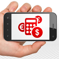 Image showing Finance concept: Hand Holding Smartphone with Calculator on display
