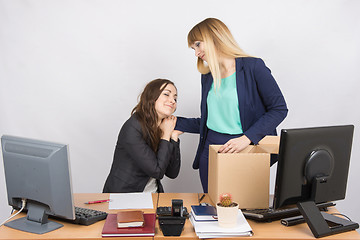 Image showing The girl in the office is facing the box with things and says goodbye to a colleague