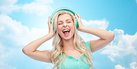 Image showing happy young woman or teenage girl with headphones