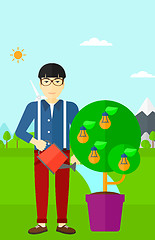 Image showing Man watering tree with light bulbs.