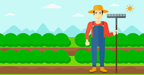 Image showing Farmer with rake.