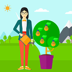 Image showing Woman watering tree with light bulbs.