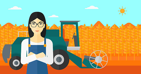 Image showing Woman standing with combine on background.