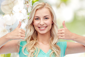 Image showing happy woman or teenage girl showing thumbs up