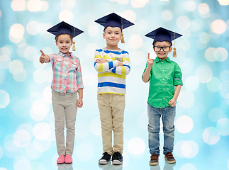 Image showing happy children in bachelor hats and eyeglasses