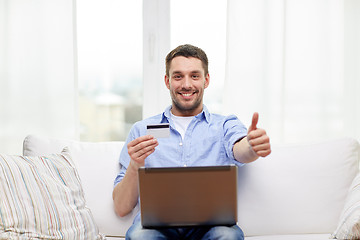 Image showing man with laptop and credit card showing thumbs up