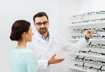Image showing woman and optician showing glasses at optics store