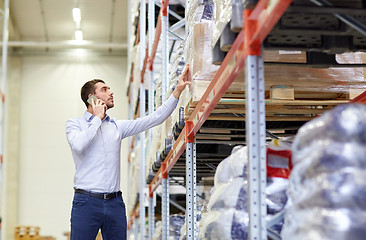 Image showing serious man calling on smartphone at warehouse