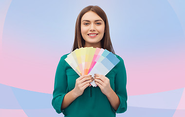 Image showing smiling young woman with color swatches