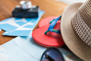 Image showing close up of travel tickets, flip-flops and hat